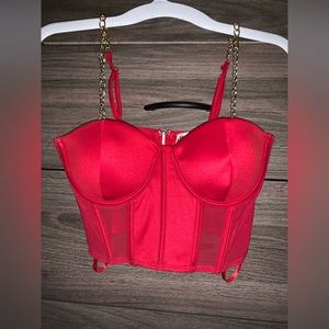 Red bustier corset top with gold metal straps